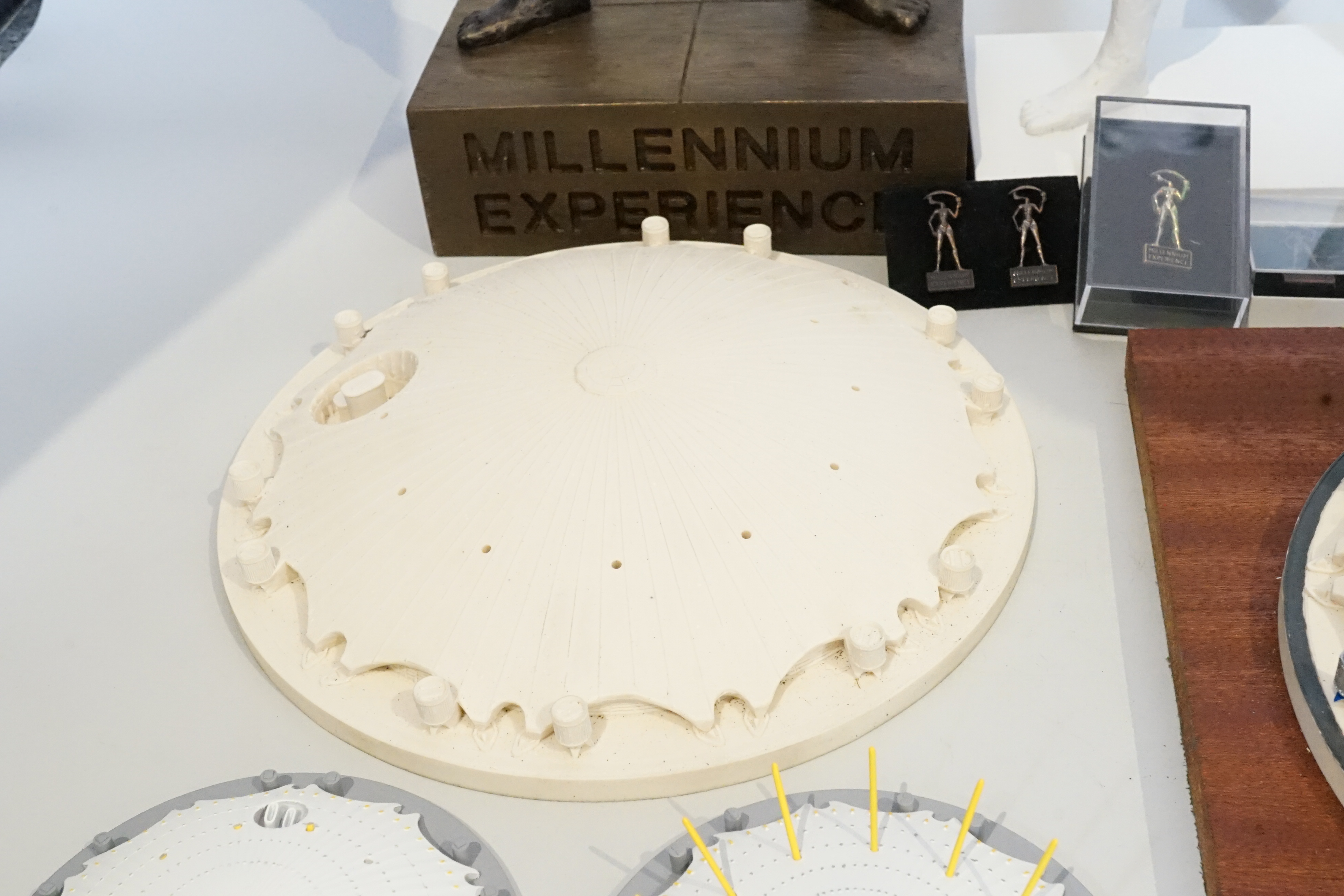 Two prototype diecast Millennium Dome models, other prototype Millennium Dome resin models and two unique Millennium Experience figures for pin development, designed by Mark Reddy, one plaster cast from clay